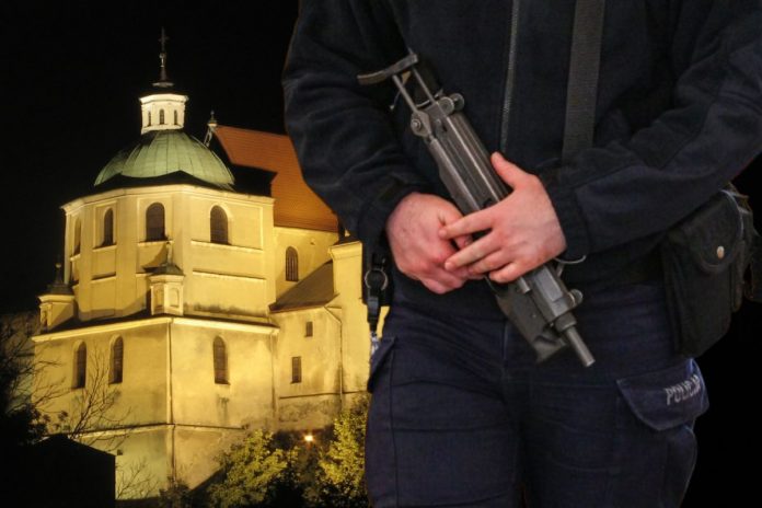 Klasztor dominikanów w Lublinie oraz policjant z bronią.